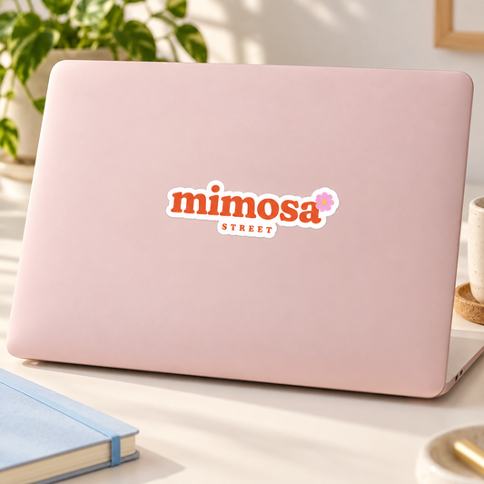 Mimosa Street 4-inch logo sticker on a blush pink laptop — lifestyle mockup